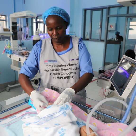 NICU at Masaka Regional Referral Hospital - Health worker cares for newborn.