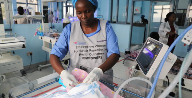 NICU at Masaka Regional Referral Hospital - Health worker cares for newborn.